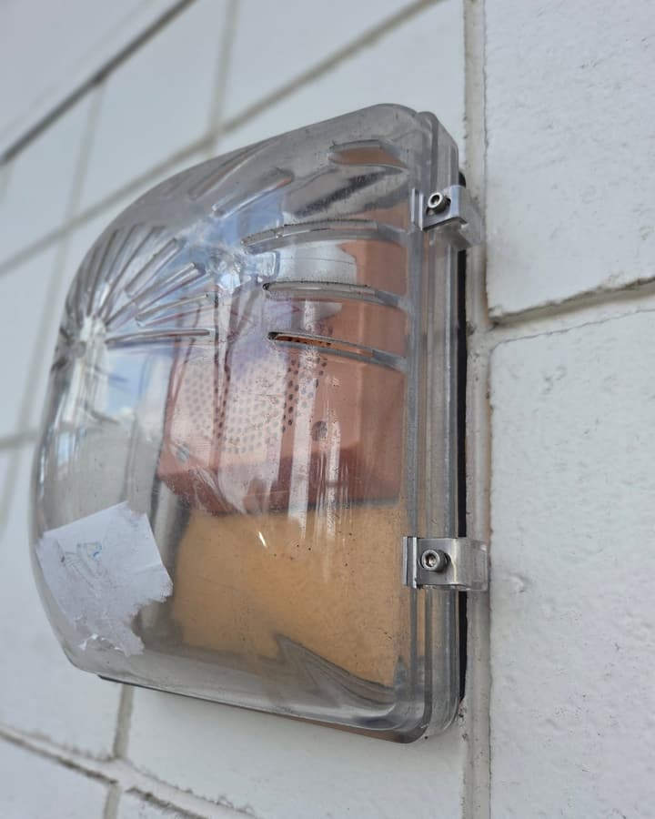 A red manual fire alarm pull station on a wall